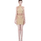 Model wearing FlyandFall's beige mock neck top and mini skirt set, featuring structured lines and functional side belts, front view.