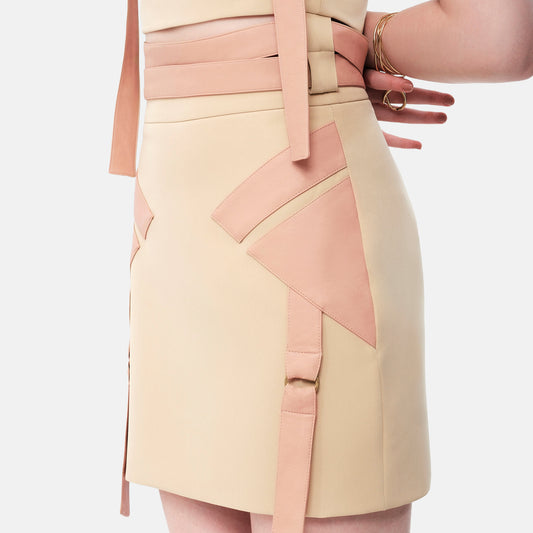 FlyandFall beige skirt close-up with geometric shapes and soft beige structure, modern American fashion design.