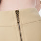 FlyandFall beige zipper close-up showing precise stitching and fine metal detailing in soft beige fabric.