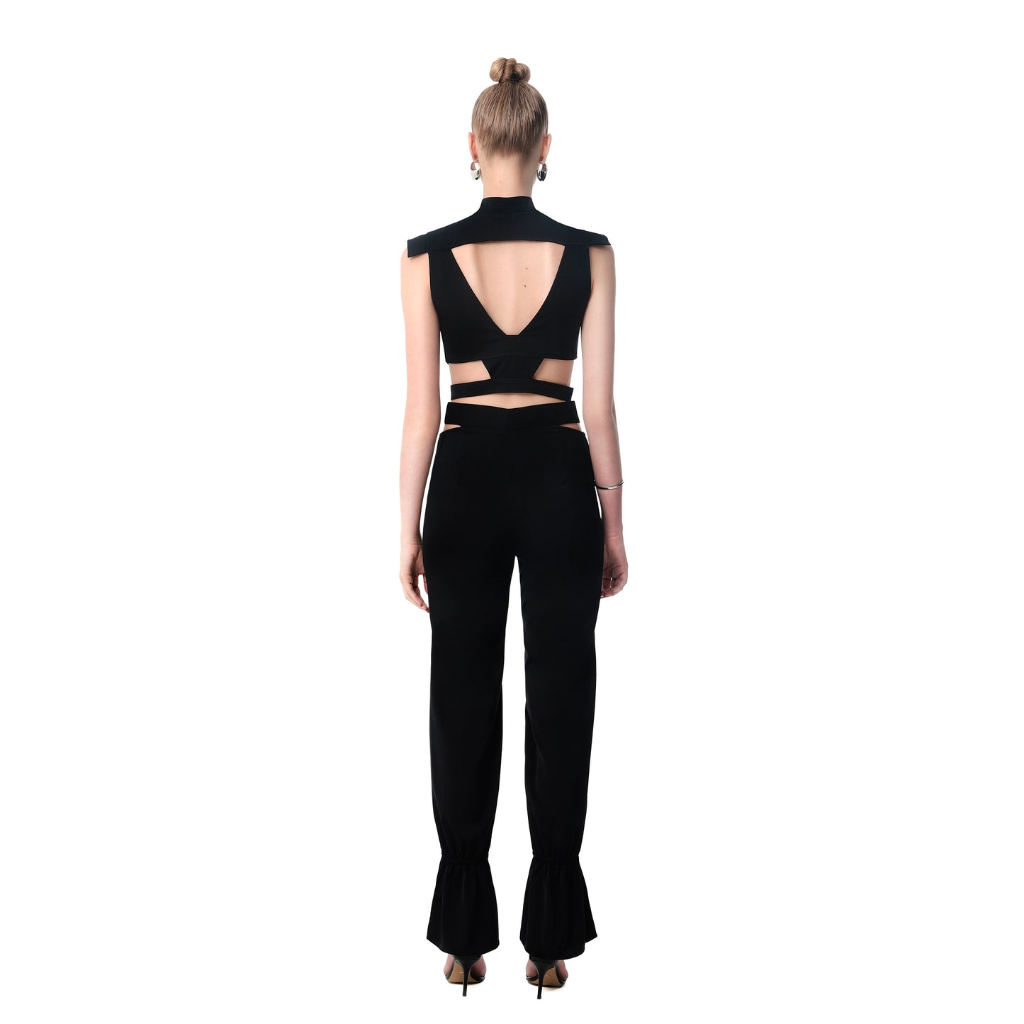 Back view of FlyandFall black cutout crop top with open back and high-waisted pants