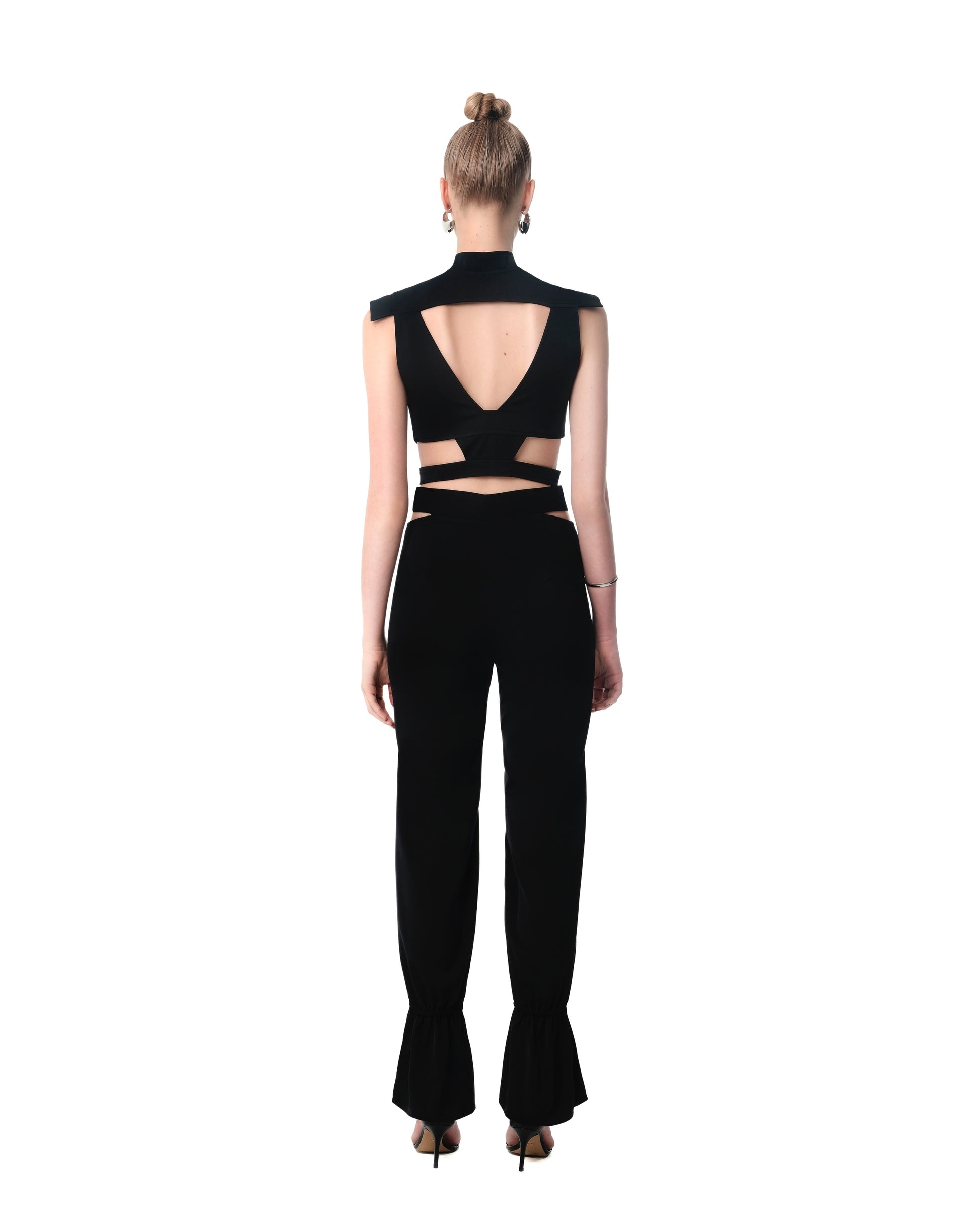 Rear view of FlyandFall’s structured set, featuring an open-back crop top and layered waist cutouts.