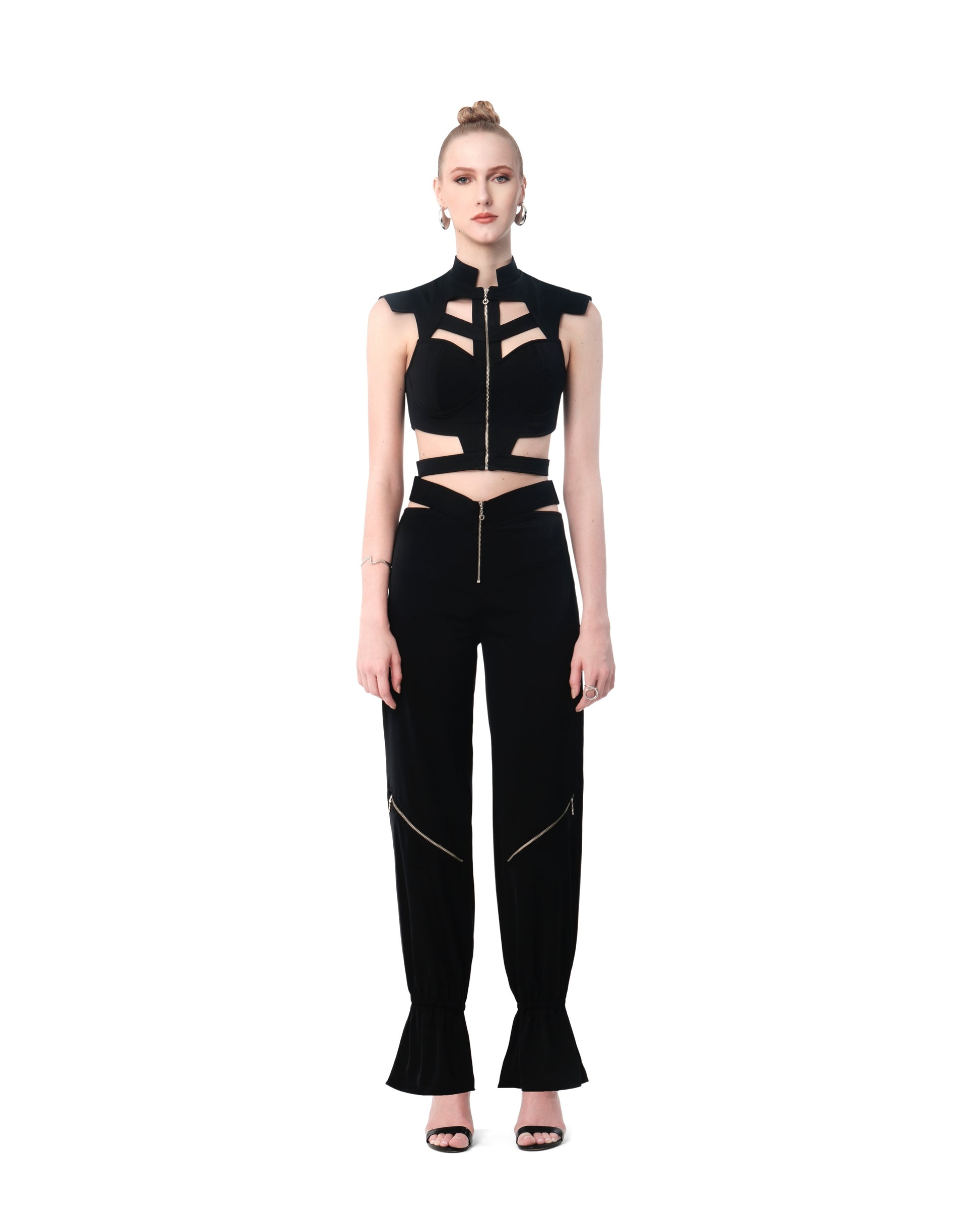 Model in FlyandFall’s black cutout crop top and high-waisted pants, styled with a sleek, sculptural silhouette.