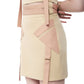 Close-up of FlyandFall's side appliqué and adjustable belt on beige mini skirt, highlighting sustainable design.
