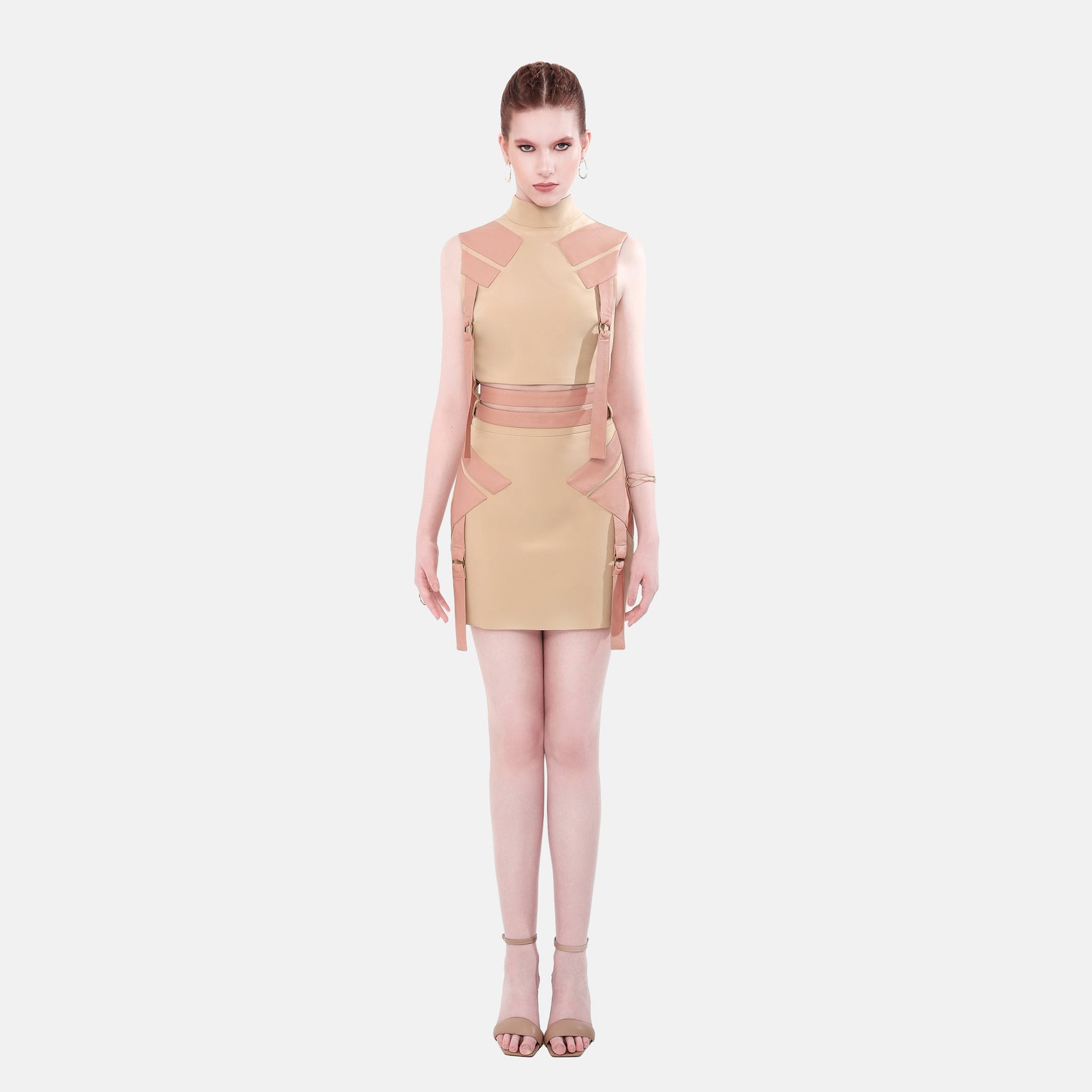 FlyandFall beige structured mini dress front view, modern design with geometric panels and soft neutral tone.