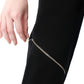 Close-up of the diagonal leg zipper on FlyandFall’s high-waisted pants, showcasing metallic edge and form.