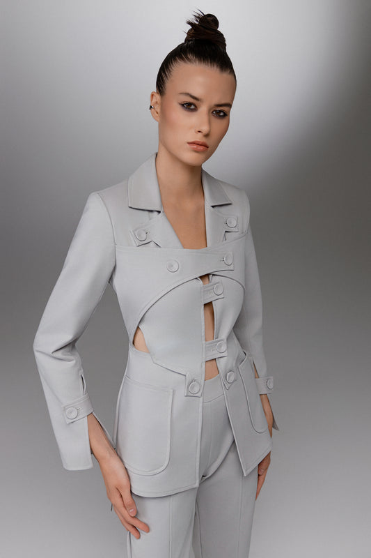 KAEL gray deconstructed cutout suit front view showing interlocking button tabs layered blazer panels and tailored pockets