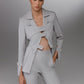 KAEL gray deconstructed suit with open front blazer showing cutout panels and button details with tailored trousers