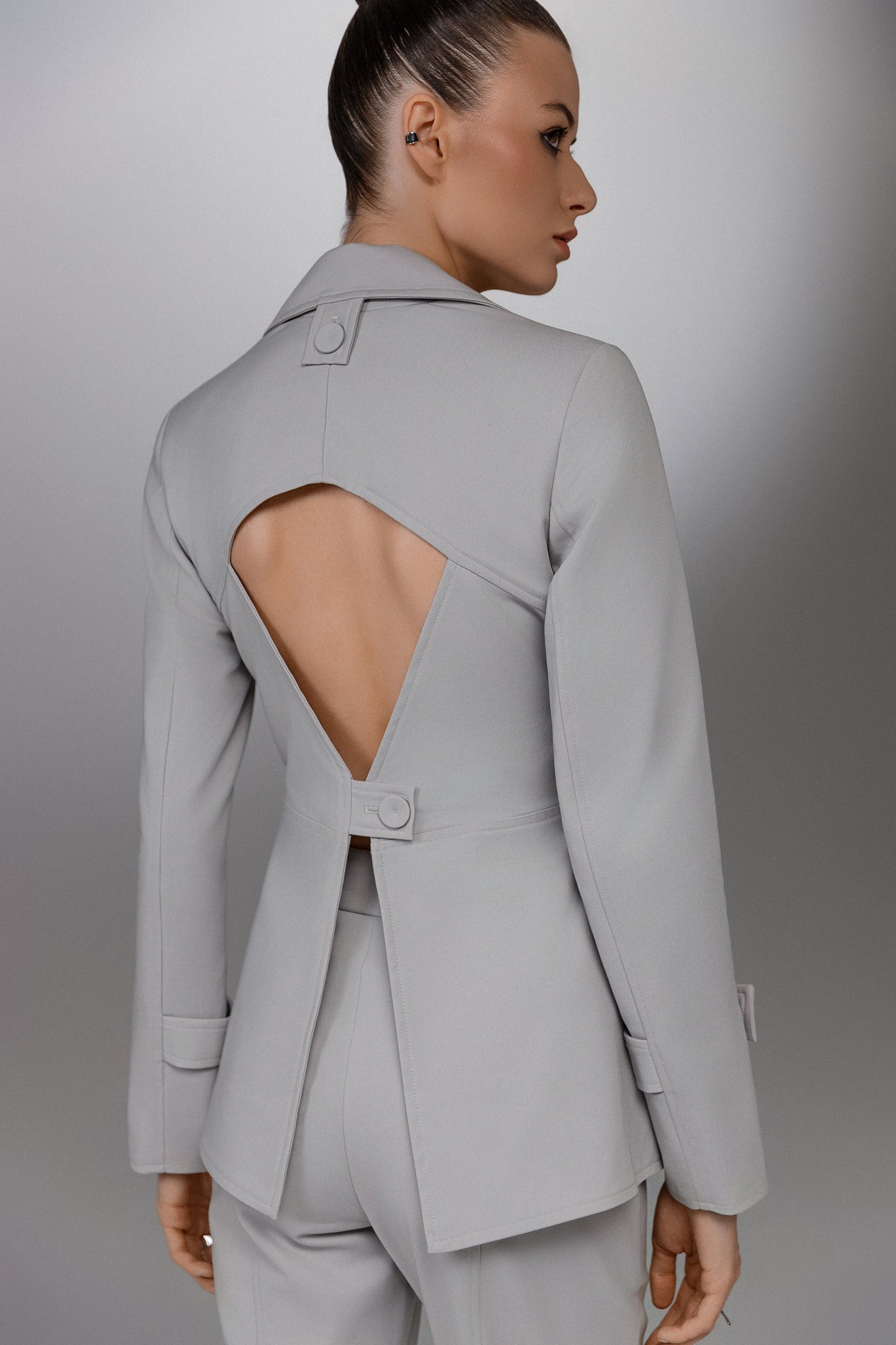 KAEL gray deconstructed suit blazer from the back showing the large geometric cutout and button closure