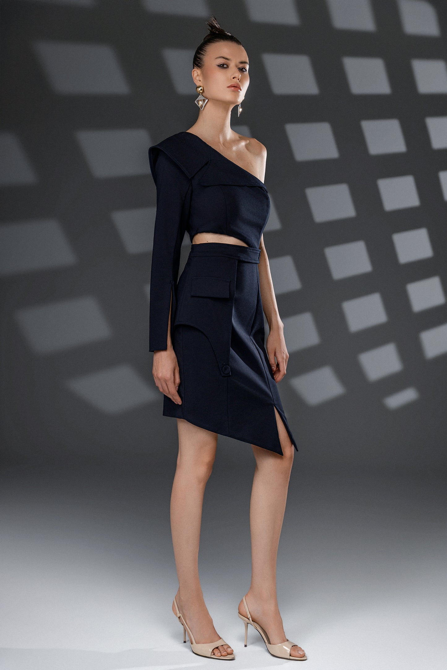 NERIS dark blue asymmetric cutout dress full-length front view with one-shoulder neckline and asymmetric hemline