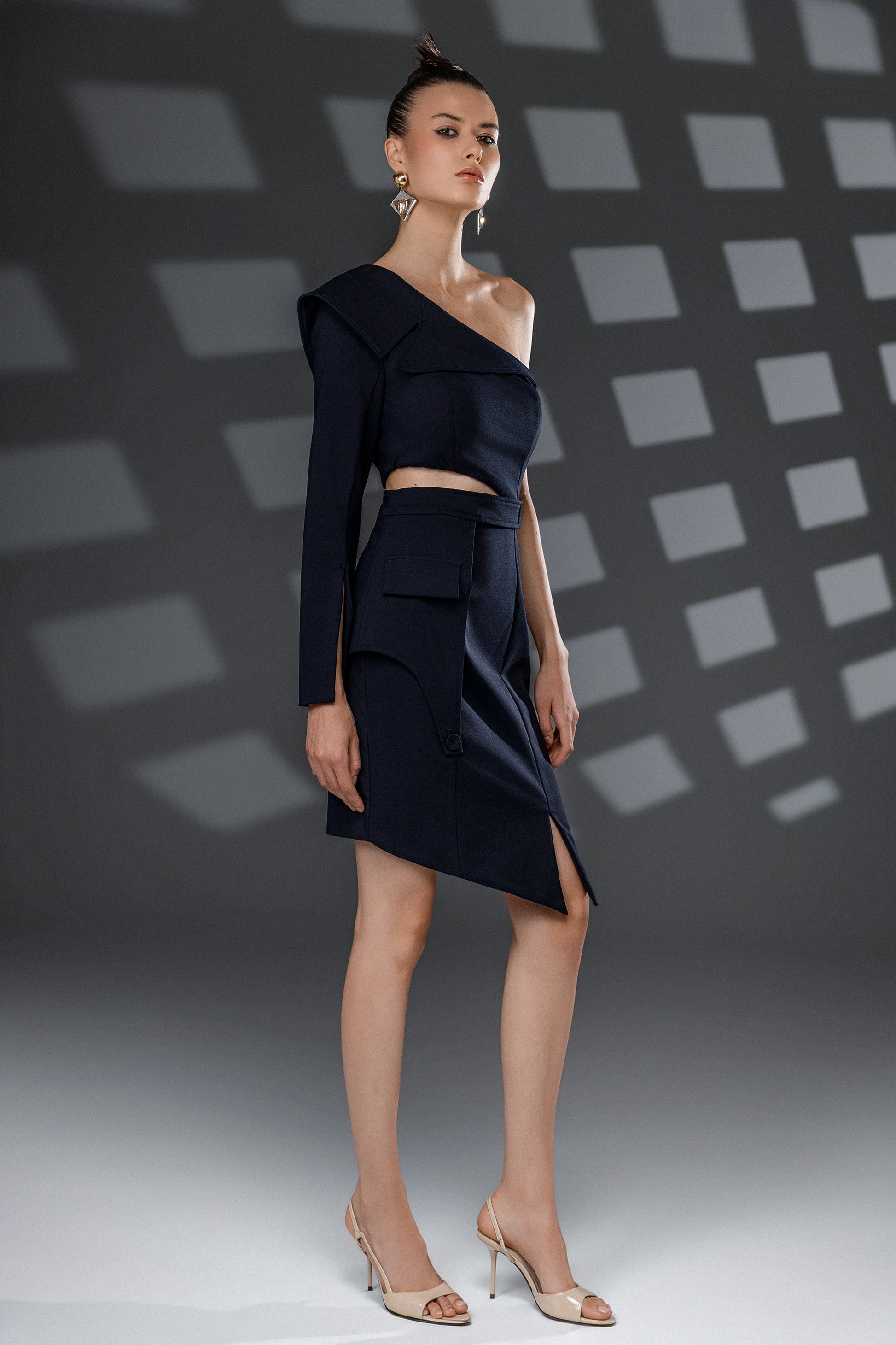 NERIS dark blue asymmetric cutout dress full-length front view with one-shoulder neckline and asymmetric hemline