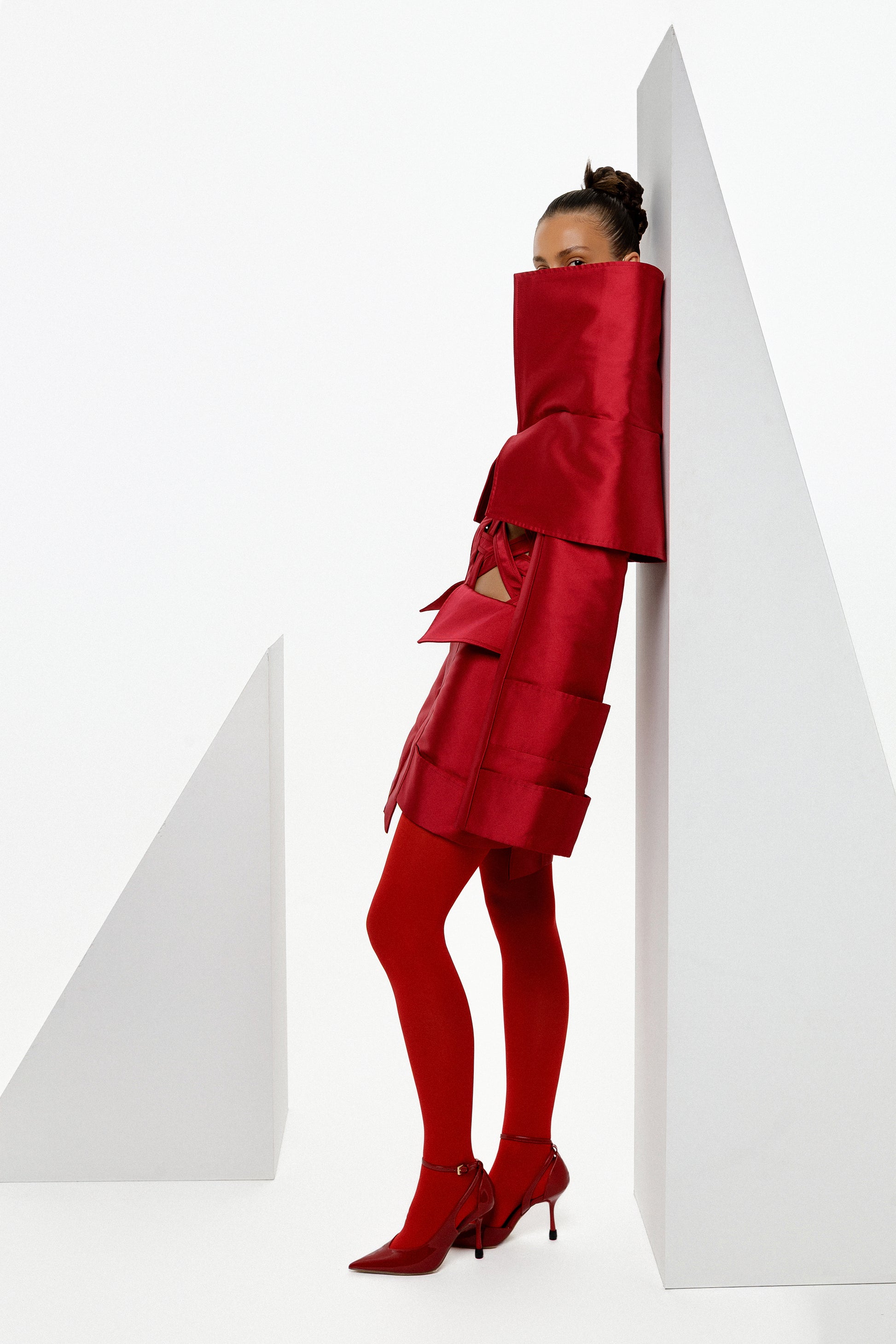 Obsidian Bloom red Mikado editorial mini dress photographed against geometric forms with sculptural high collar and architectural detailing by FlyandFall