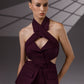 VEYRA Burgundy Crossover Halter Jumpsuit front detail showing the crossover halter neckline, chest cutout, covered buttons and structured hip panels.
