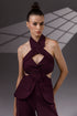 VEYRA Burgundy Crossover Halter Jumpsuit front detail showing the crossover halter neckline, chest cutout, covered buttons and structured hip panels.